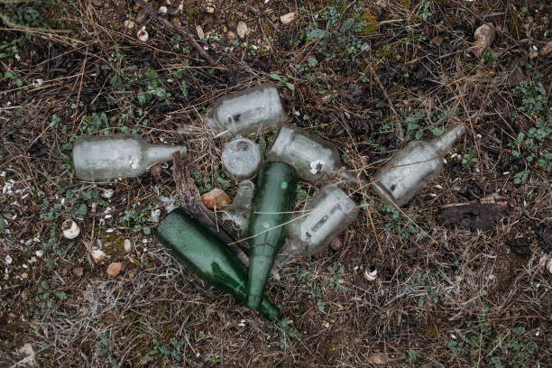 istock Garbage, glass bottles are lying on the ground 2102093121