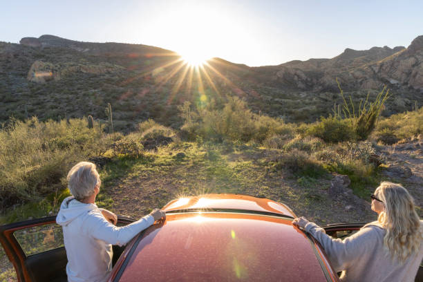 istock Mature couple park car in desert 2102096781