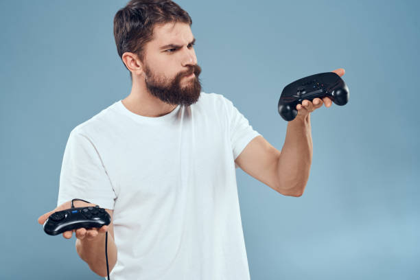 istock Cheerful man with joysticks in hands lifestyle leisure blue background 2102113888