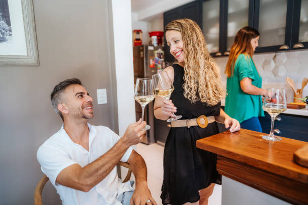 istock Friends Enjoying Wine Together in a Cozy Kitchen 2102125392