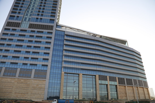 Abu Dhabi, United Arab Emirates - November 1, 2019: Etihad towers modern skyscrapers at the downtown Abu Dhabi in the United Arab Emirates capital city with cloudy sky