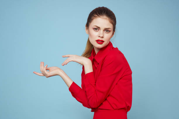 istock attractive woman in bright clothes on blue background gesturing with hands and red lips makeup cropped view emotions 2102137434