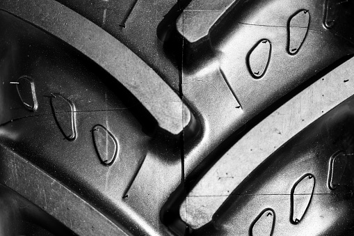 Detail shot with brand new tractor tire. Treads details.
