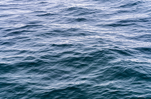 Wave patterns and a swell on the ocean surface in deep water.