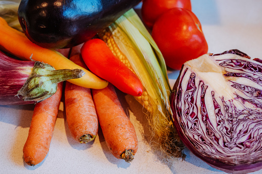 A vibrant selection of fresh vegetables arranged on a kitchen countertop, highlighting healthy eating and culinary preparation.