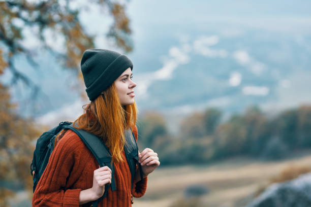 istock woman hiker with backpack nature vacation walk adventure 2102192673