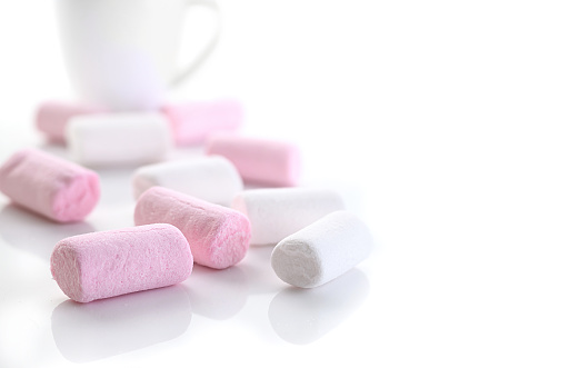 White and Pink Marshmallows on white background. Selective focus, shallow DOF