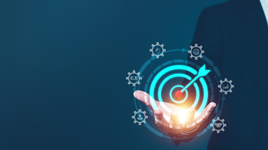 Businessman hand holds target icon with an arrow. Set the organization goal and the direction of the marketing strategy plan, Concept achieve future goal and sustainable, Business with all-round goal.