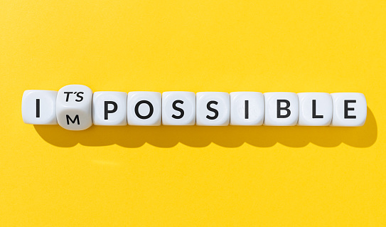 Changing message impossible into it is possible. Cube blocks with text isolated on yellow background