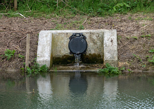 Industrial Water Overflow Pipe Into A Canal