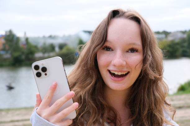 istock Happy young woman exercising photographed using a mobile phone camera 2102221967
