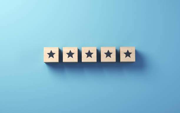 istock Star icon on wooden blocks standing on blue background, Customer Satisfaction feedback concept 2102239226