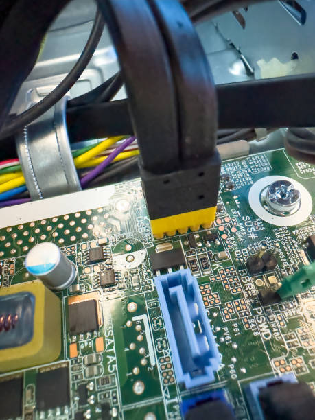 Close up of circuit board with microchips and other computer parts. Cables and Circuitry.