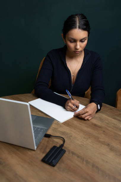 istock Brunette young woman working on laptop 2102244506