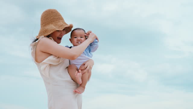 Mother Holding Baby on Beach, Serene Ocean vacation