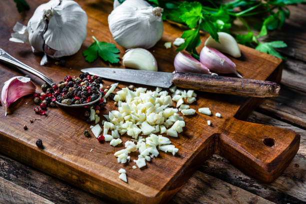 istock Chopped garlic on wooden cutting board 2102315230