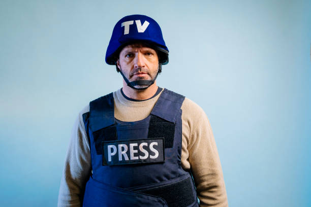istock Reporter with bulletproof vest in the studio. 2102327124