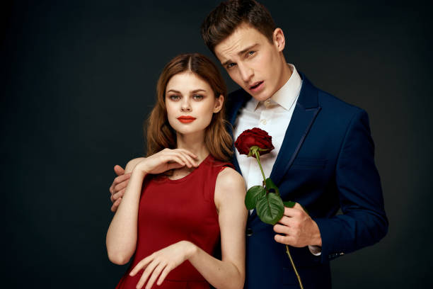istock luxury couple hug romance relationship rose over dark isolated background 2102327126