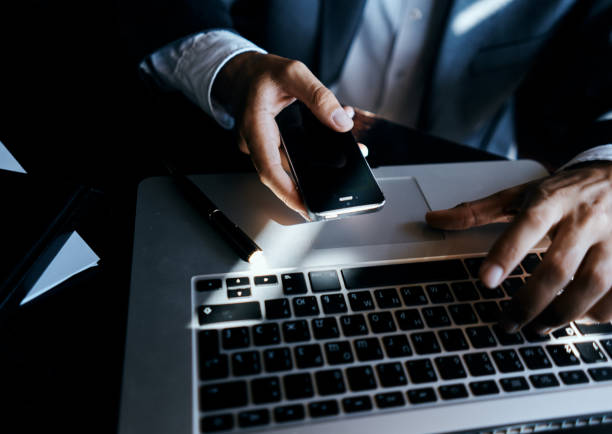 istock Business man with phone in hand laptop technology communication lifestyle 2102345032