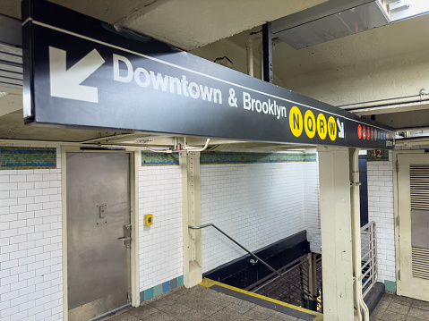 Downtown sign in a subway station in New York City