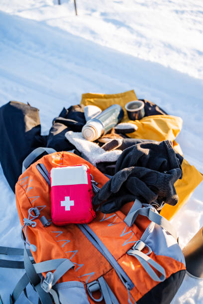 istock An electric blue first aid kit on an orange backpack in the snow 2102353916