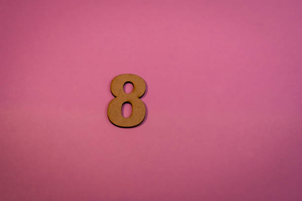 istock Number 8 in wood on a pink background 2102353919