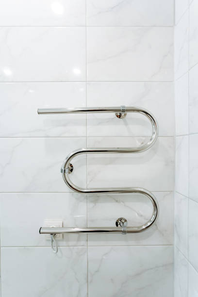 istock Rectangle stainless steel towel rack on white tiled wall 2102354490