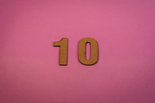 istock Number 10 in wood on a pink background 2102355530