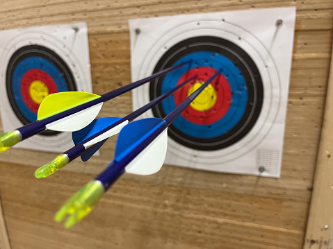 Three arrows in a target close to bull's-eye and focus on the target