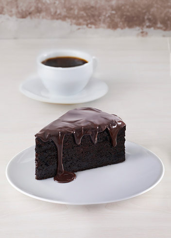 An Easter sand cake covered with chocolate, held in hands