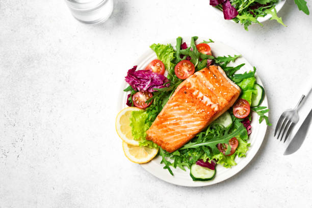 istock Grilled salmon steak and vegetable salad 2102358821