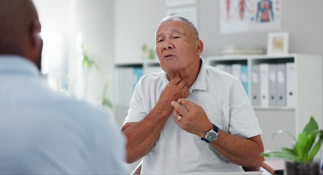 Senior, man and consulting doctor on sore throat, pain or discomfort in healthcare at hospital. Mature, male person or patient talking to medical employee for diagnosis, prescription or inflammation
