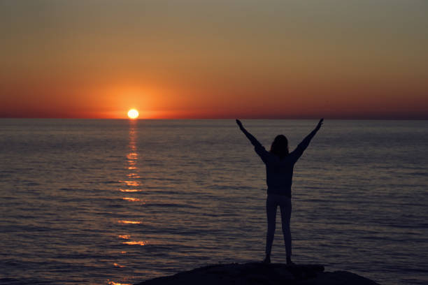 istock Beach mountains landscape sun sunset female silhouette 2102410663