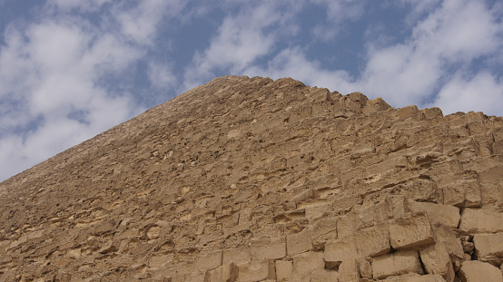 Two mens standing in front the pyramid. The Great Pyramid of Giza is the oldest and largest of the three pyramids in the Giza pyramid complex.