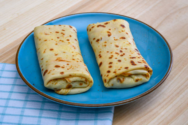 istock Two thin pancakes filled with filling, a delicious dinner 2102437016