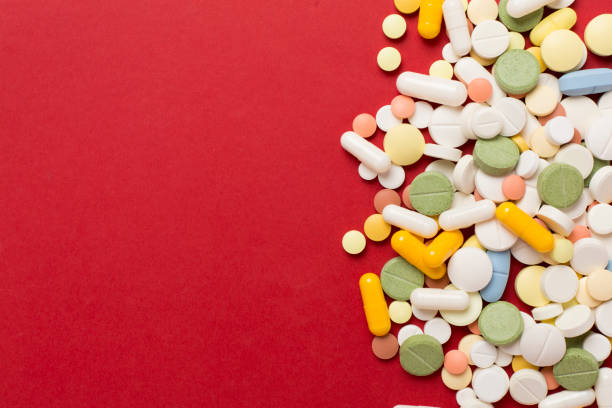 istock Different medical pills and capsules on color background, top view 2102455931