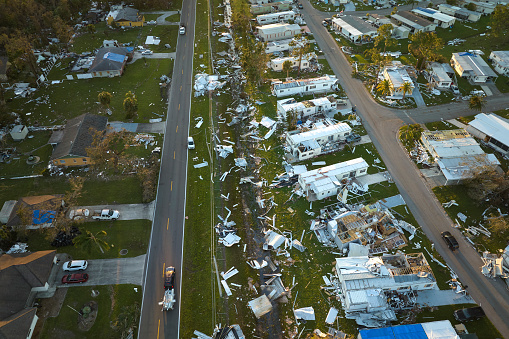 Badly damaged mobile homes after hurricane Ian in Florida residential area. Consequences of natural disaster.