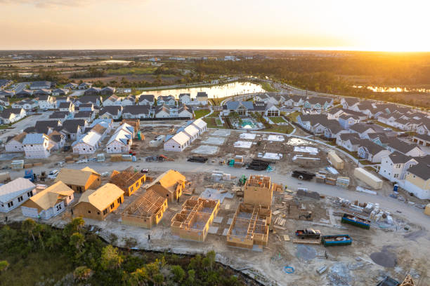 istock Construction in new developing suburban area. Development of residential housing in American suburbs. Real estate market in the USA 2102472937