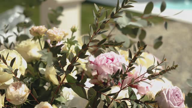 Close-up bouquet of of fresh pink and yellow roses with green leaves, close-up slow motion.