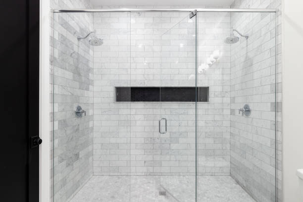 istock A bathroom shower with marble subway and black hexagon tiles. 2102483681