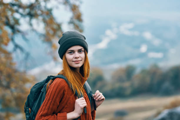 istock woman hiker with backpack nature vacation walk adventure 2102484760