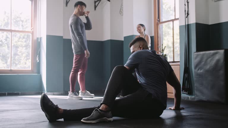 African American athlete stretches in fitness studio