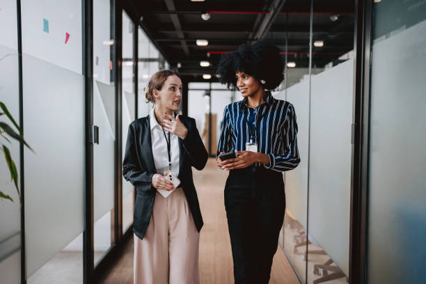 istock Employees walking down the company corridor 2102524445