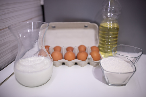 Ingredients for making bread on the table. Egg, milk, flour, oil, sugar