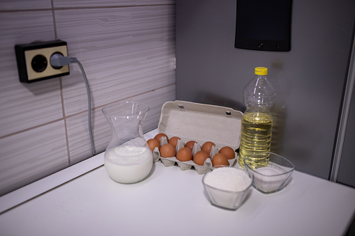 Ingredients for making bread on the table. Egg, milk, flour, oil, sugar