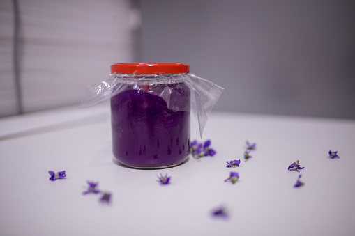 Sweet purple Viola wildflower jam on the table