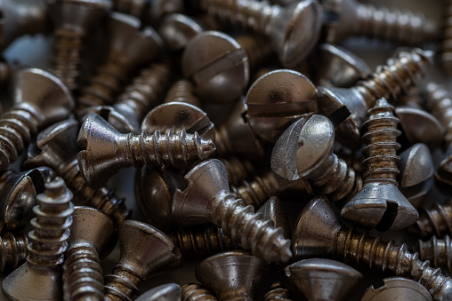 Close-up of a pile of small silver colored screws