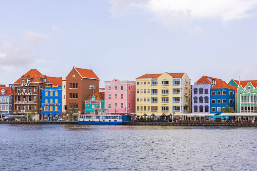 Willemstad Curacao. 03.21.2024. Breathtaking panorama of colorful houses nestled in the heart of Willemstad, overlooking St. Anna Bay with a backdrop of a cloudy sky.