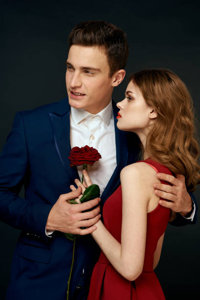 istock luxury couple hug romance relationship rose over dark isolated background 2102562581