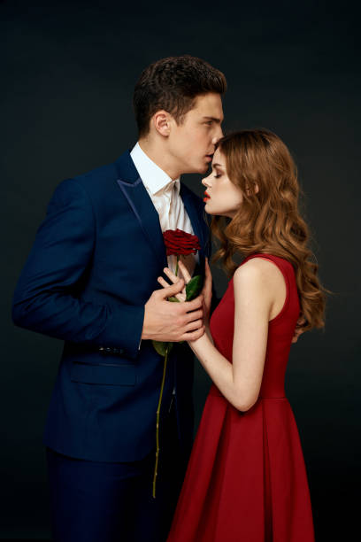 istock luxury couple hug romance relationship rose over dark isolated background 2102575332